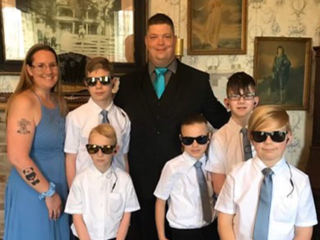 Staff Sgt Adam Proctor with his wife and five sons.