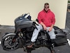 Staff Sgt Adam Proctor sitting on his motorcycle.