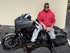 Staff Sgt Adam Proctor sitting on his motorcycle.