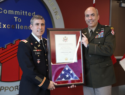 Lieutentant Colonel Dan Segura, Huntsville Center deputy commander, is presented with a retirement certification.