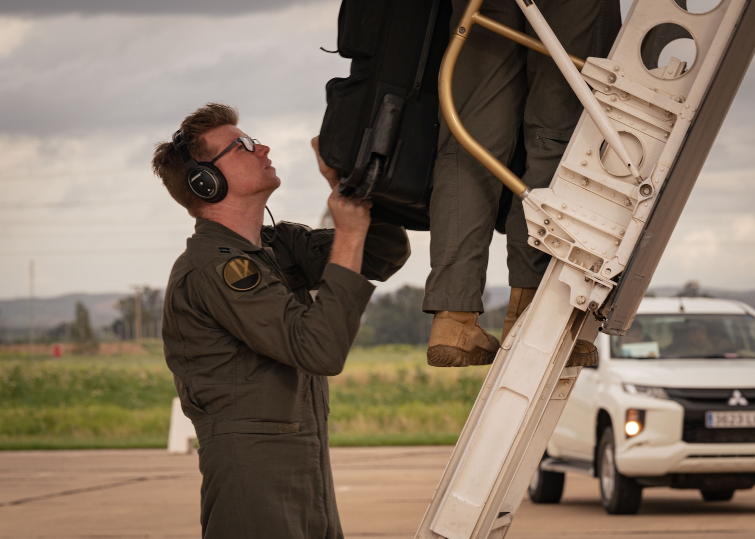 U.S. Air Force Capt. Kendall Curtis, aircrew with the 9th Expeditionary Bomb Squadron from Dyess Air Force Base, Texas, helps unload gear from a B-1B Lancer at Morón Air Base, Spain, in support of Bomber Task Force Europe, March 26, 2024. BTF 24-2 is a demonstration of NATO Allies and partner nations' ability to seamlessly operate together to maintain a stable and prosperous Euro-Atlantic region. This sends a strong message to potential adversaries, deters aggression, enhances stability, and assures Euro-Atlantic publics. (U.S. Air Force photo by Senior Airman Zachary Wright)