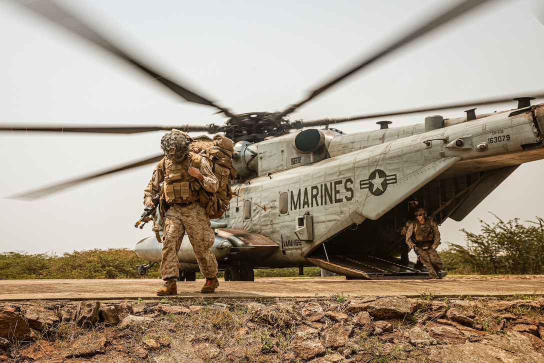 U.S. Marines assigned to Charlie Company, Battalion Landing Team 1/5, 15th Marine Expeditionary Unit, exit a CH-53E Super Stallion attached to Marine Medium Tiltrotor Squadron (VMM) 165 (Reinforced), 15th MEU, for an amphibious landing during Exercise Tiger TRIUMPH at Kakinada Beach, India, March 27, 2024. Tiger TRIUMPH enables U.S. and Indian Armed Forces to improve interoperability and bilateral, joint, and service readiness in the Indian Ocean region and beyond to better achieve mutual regional security objectives.