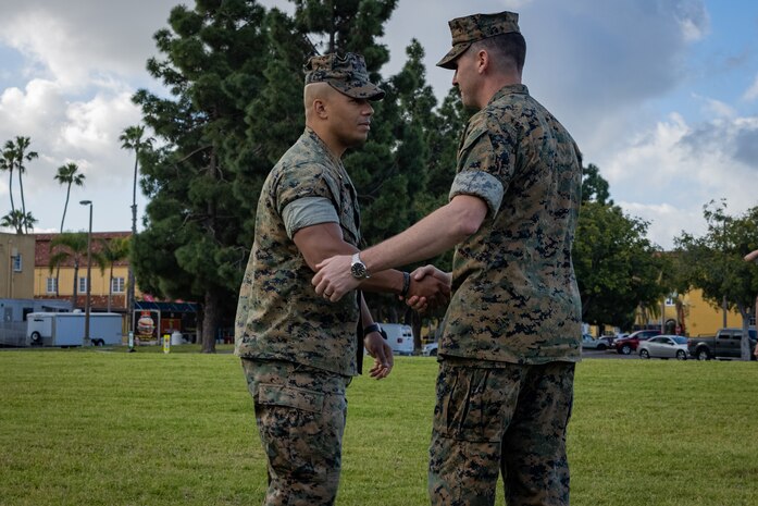U.S. Marine Corps Maj. Jeshua Alston, left, and Capt. Ryan Schaub, right, both with Service Company, Headquarters and Service Battalion, shake hands during a change of command ceremony at Marine Corps Recruit Depot San Diego, March 29, 2024. Capt. Ryan Schaub relinquished his position to Maj. Jeshua Alston, who took charge as Service Company Commanding Officer. (U.S. Marine Corps photo by Lance Cpl. Jacob B. Hutchinson)