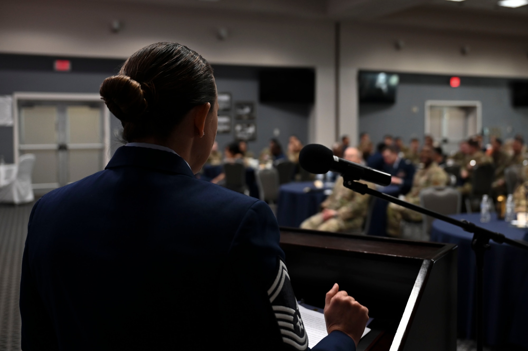 U.S. Air Force Senior Master Sgt. Crystal Doepker, 17th Comptroller and Wing Staff Agencies senior enlisted leader, addresses the Airman Leadership School class graduates during the Class 24-C graduation at the Powell Event Center, Goodfellow Air Force Base, Texas, March 29, 2024. Students gain an understanding of their role as military supervisors and how they contribute to the overall goals and mission of the Air Force. (U.S. Air Force photo by Airman 1st Class Madison Collier)