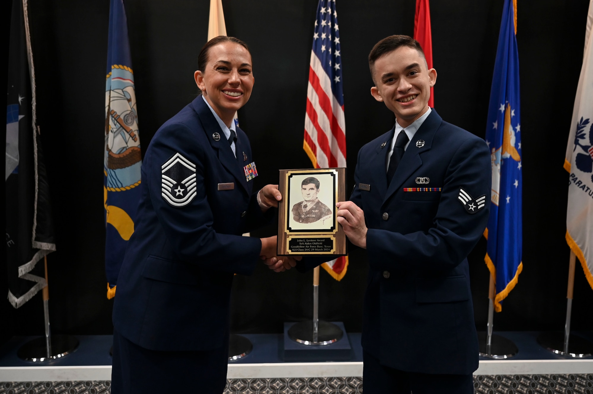 U.S. Air Force Senior Airman Aden Oldfield, 47th Operations Support Squadron, is presented the John L. Levitow Award by Senior Master Sgt. Crystal Doepker, 17th Comptroller and Wing Staff Agencies senior enlisted leader. ALS is a five-week course designed to prepare senior airmen to assume supervisory duties through instruction in leadership, followership, written and oral communication skills, and the profession of arms. (U.S. Air Force photo by Airman 1st Class Madison Collier)