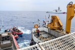 Crews from Coast Guard cutters Hamilton (WMSL 753) and Munro (WMSL 755) exchange cutter boats in the Pacific Ocean, March 12, 2024.  Hamilton and Munro are national security cutters