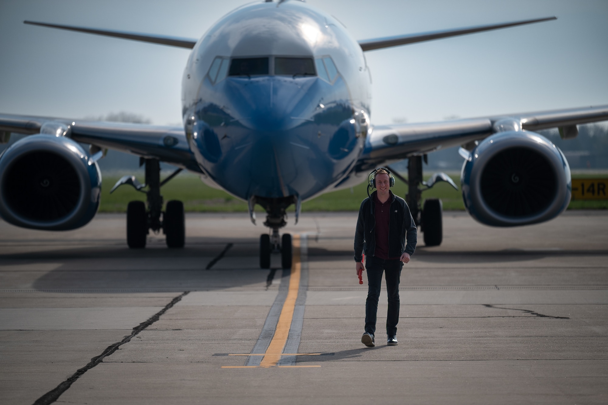 Tech Sgt. Damien Ford, 932nd Maintenance Squadron, flying crew chief, assists in parking a returning 932nd Airlift Wing C-40c after disembarking from the aircraft short of the final parking spot, March 31, 2024, Scott Air Force Base, Illinois. (U.S. Air Force photo by Christopher Parr)