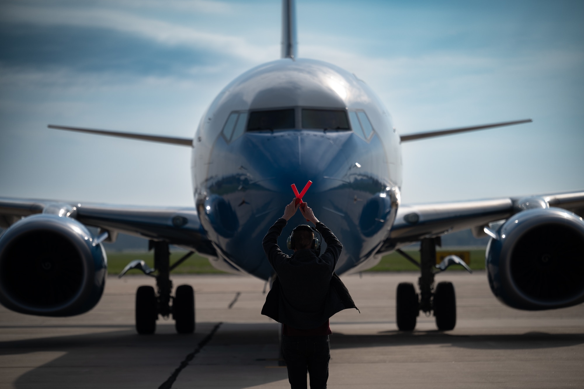 Tech Sgt. Damien Ford, 932nd Maintenance Squadron, flying crew chief, assists in parking a returning 932nd Airlift Wing C-40c after disembarking from the aircraft short of the final parking spot, March 31, 2024, Scott Air Force Base, Illinois. (U.S. Air Force photo by Christopher Parr)