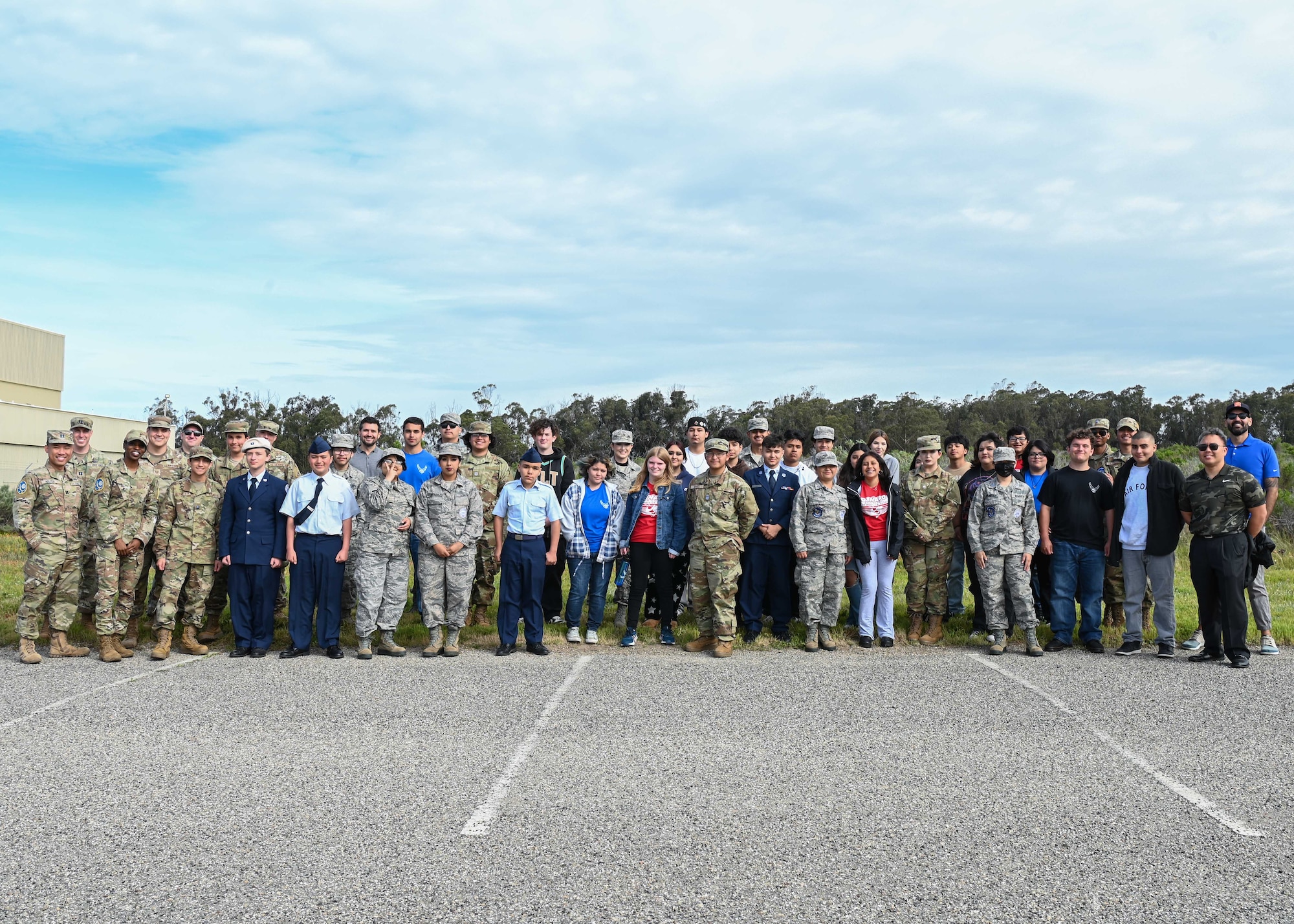 Military members from the 2nd Space Launch Squadron and Oxnard High School JROTC cadets pose for a group photo during a tour at Vandenberg Space Force Base.