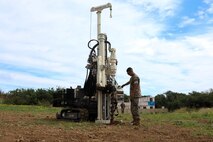 U.S. Marine Corps Lance Cpl. Micheal Garza, expeditionary airfield technician, Marine Wing Support Squadron 174, Marine Aircraft Group 24, 1st Marine Aircraft Wing operates the GeoProbe Rock Drill at Marine Corps Base Hawaii, March 19, 2024. The GeoProbe is a multi use piece of equipment that will assist the Marines in drilling and driving anchors for expeditionary airfield matting and arresting gear. (U.S. Marine Corps photo by Lance Cpl. Marcos AlbertoRocha)