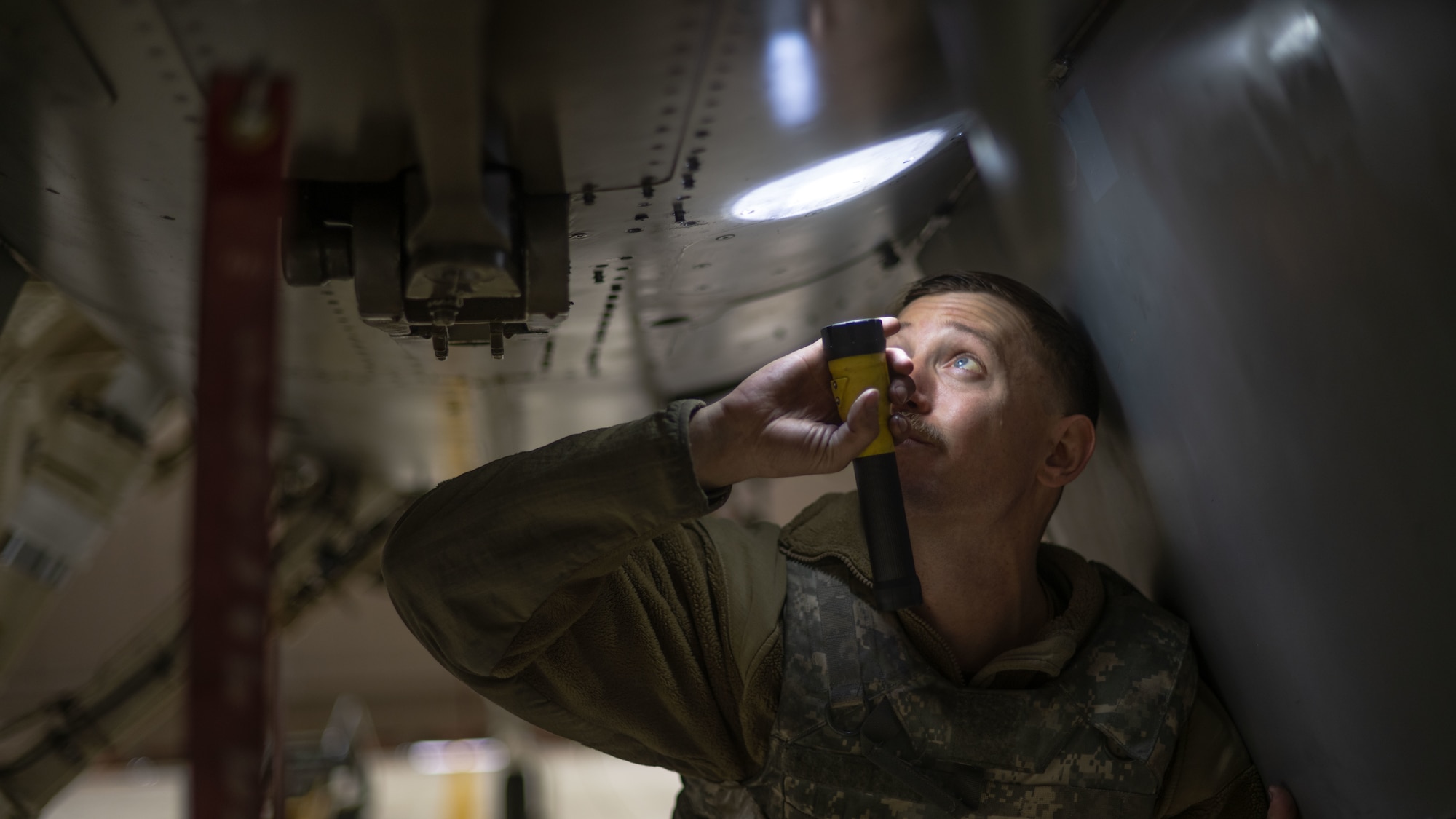 Senior Airman Joshua Welch conducts maintenance on an F-16 Fighting Falcon.
