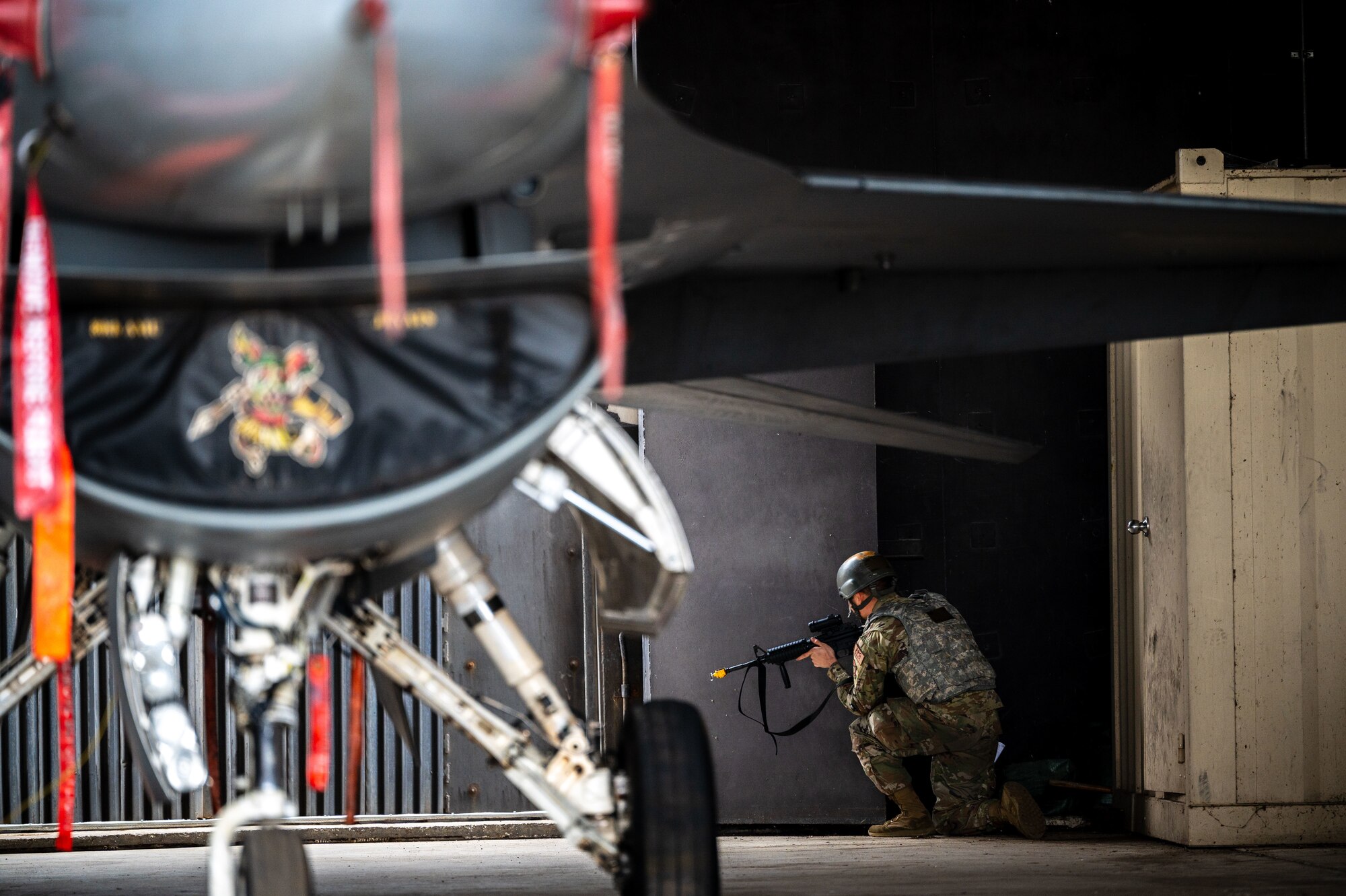 An Airman from the 80th Fighter Generation Squadron guards an F-16 Fighting Falcon.