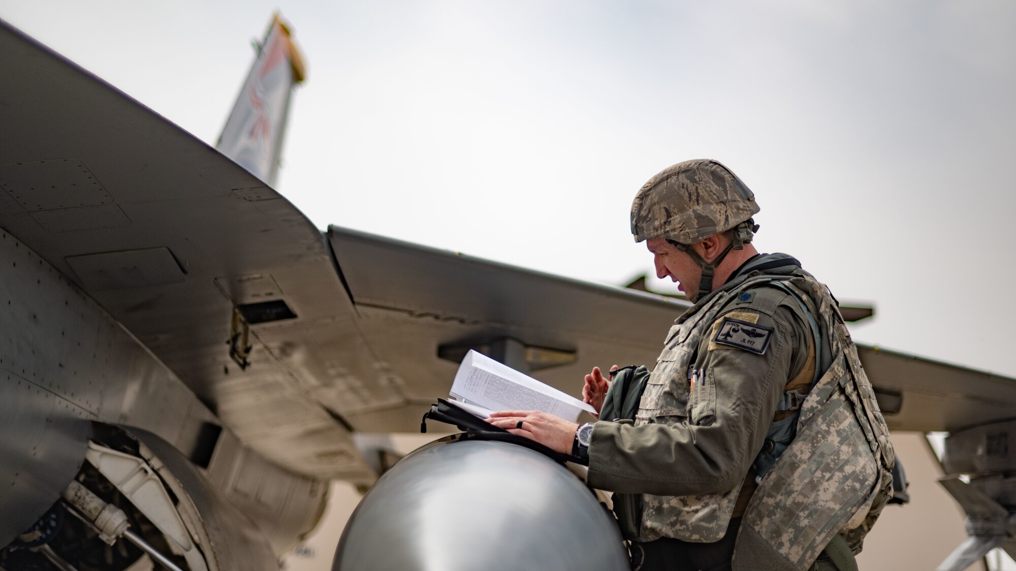 Lt. Col. Brandon July reviews aircraft certifications before flying a training sortie as part of Beverly Sentinel 24-1.