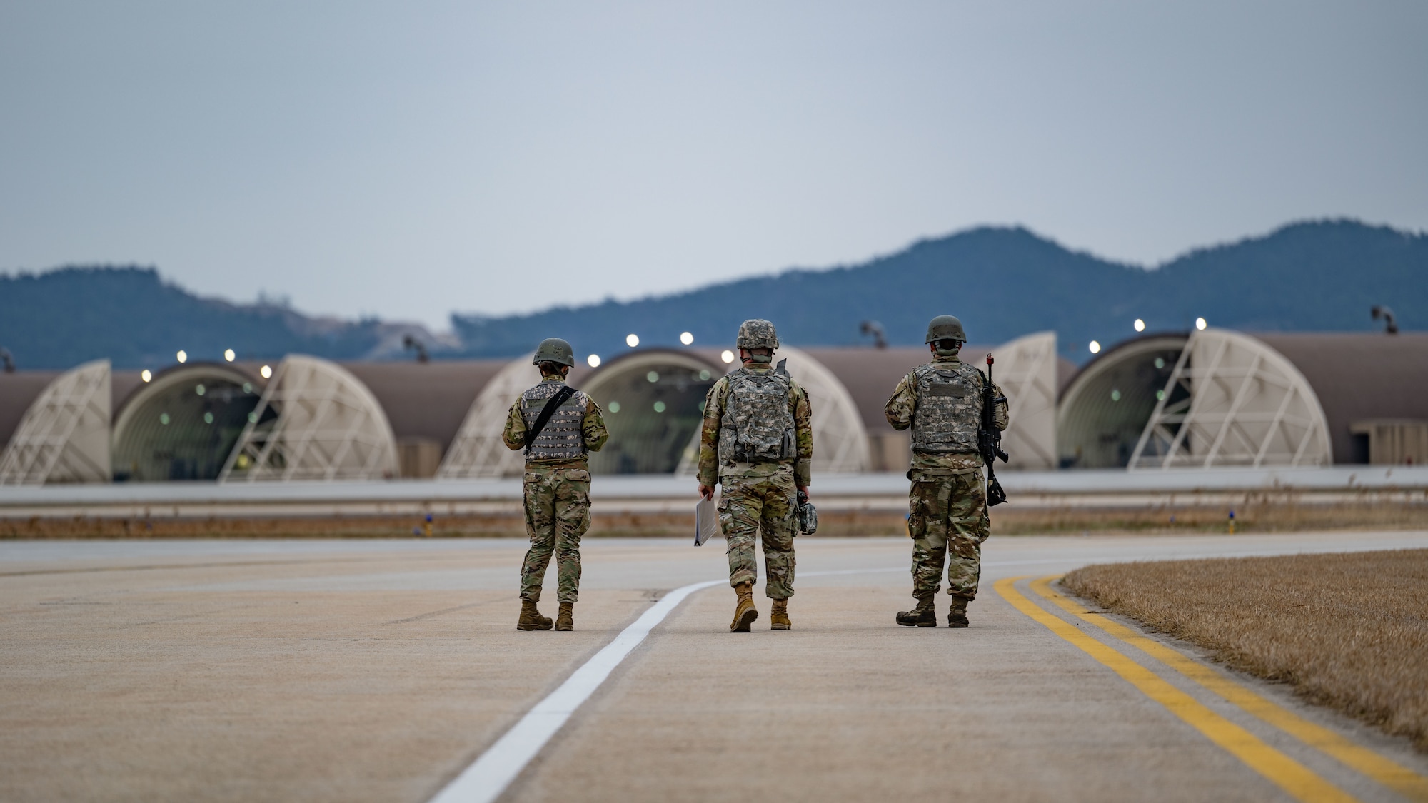 Staff Sgt. Quin Ball, Staff Sgt. Evan Fye and Senior Airman Metcalfe conduct armed guard surveillance on the flight line.
