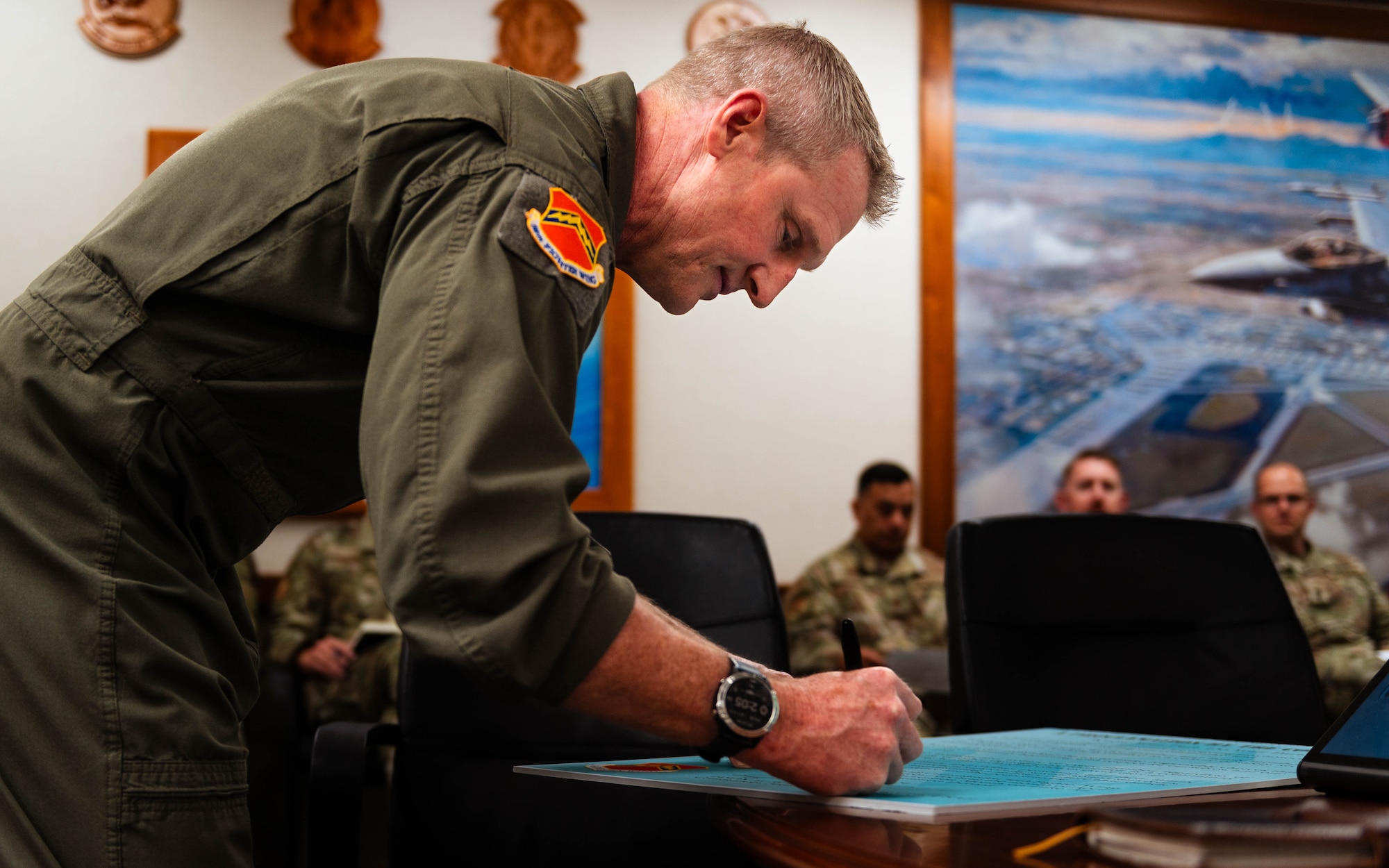 U.S. Air Force Brig. Gen. Jason Rueschhoff, 56th Fighter Wing commander, signs a proclamation dedicating the month of April as the Sexual Assault Prevention and Response month.