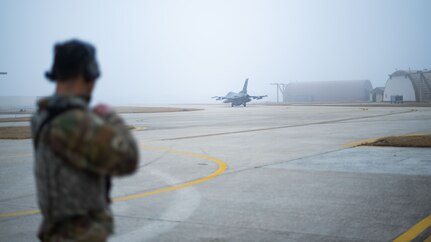 Staff Sgt. Justin Aaron conducts armed guard surveillance during an F-16 Fighting Falcon.