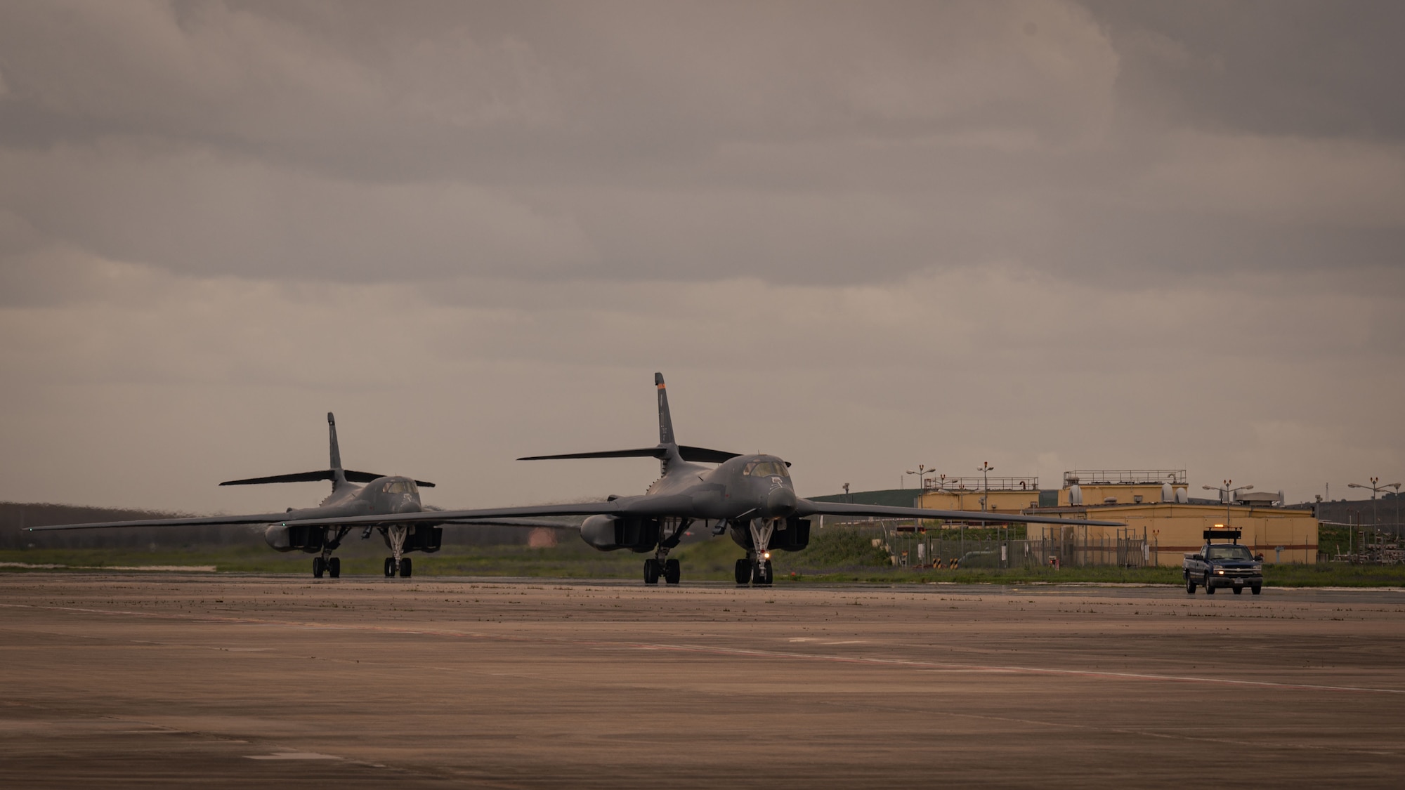 Two B-1B Lancers with the 9th Expeditionary Bomb Squadron from Dyess Air Force Base, Texas, taxi on the taxiway at Mor�n Air Base, Spain, in support of Bomber Task Force Europe, March 26, 2024. The U.S. is dedicated to security commitments to Allies and partner nations across the globe and routinely operate worldwide and maintain the agility to respond to any challenges in the operational environment. (U.S. Air Force photo by Senior Airman Zachary Wright)