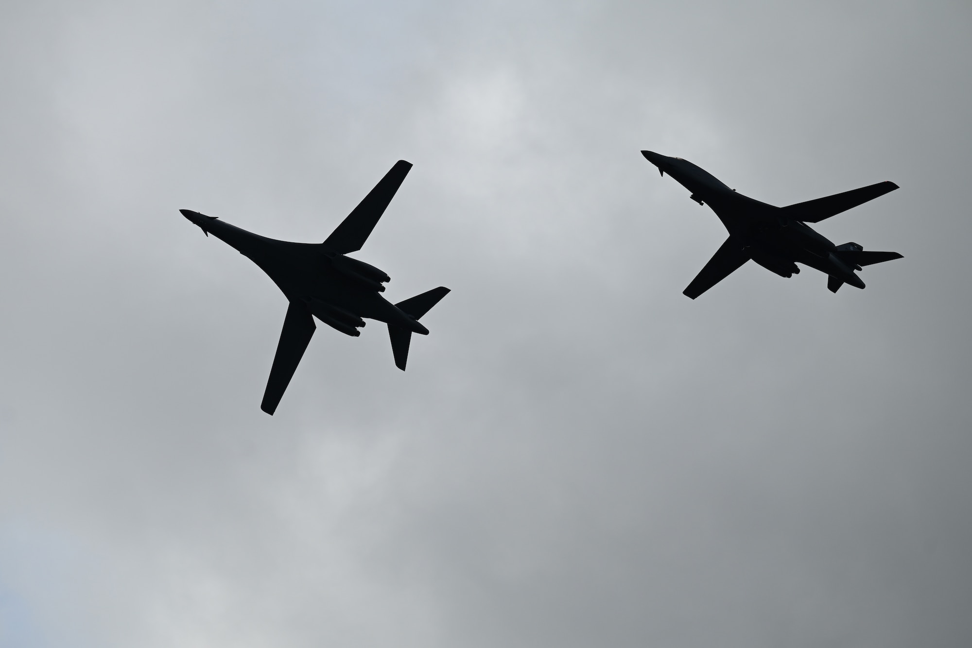 Two B-1B Lancers from Dyess Air Force Base, Texas, fly over Morón Air Base, Spain, during Bomber Task Force 24-2, March 26, 2024. Regular and routine deployments of strategic bombers provide the U.S. with critical touchpoints to train and operate alongside Allies and partners while bolstering collective response to any global conflict. (U.S. Air Force photo by Staff Sgt. Holly Cook)