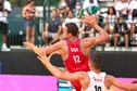 Back view of Donlin jumping above competitors with ball ready to throw