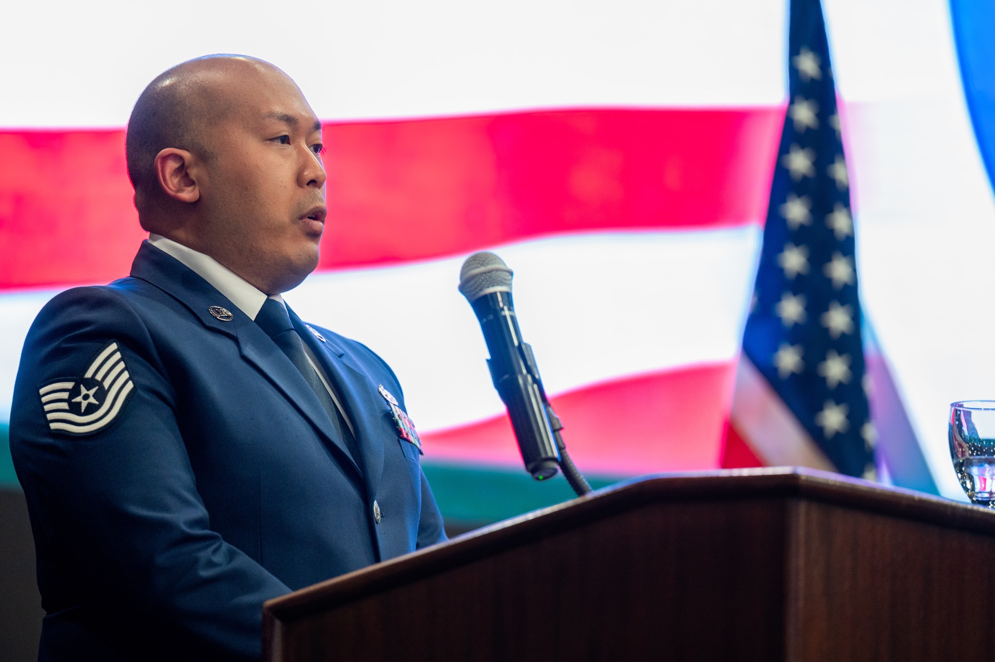 U.S. Air Force Tech. Sgt. Timothy Mims, 51st Maintenance Squadron Electronics noncommissioned officer in charge, sings the national anthem during Airman Leadership School class 24-B’s graduation at Osan Air Base, Republic of Korea, March 21, 2024. ALS is a resident Community College of the Air Force affiliated program that consists of 192 curriculum hours and teaches skills that contribute towards carrying out the “Fight Tonight” mission. (U.S. Air Force photo by Airman 1st Class Chase Verzaal)