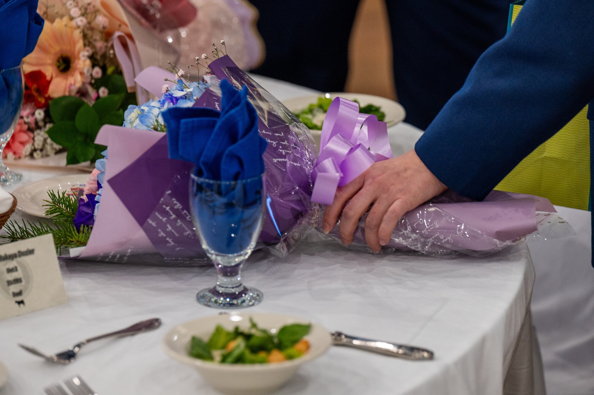 U.S. Space Force Sgt. Sara De Jesus, 73rd Intelligence, Surveillance and Reconnaissance Squadron space systems analyst, sets down flowers that she received as a gift during Airman Leadership School class 24-B graduation at Osan Air Base, Republic of Korea, March 21, 2024. ALS serves as the initial tier of professional military education for enlisted Airmen, functioning as an entry-level leadership enhancement course tailored to equip Senior Airmen with the necessary skills to assume greater responsibilities. (U.S. Air Force photo by Airman 1st Class Chase Verzaal)