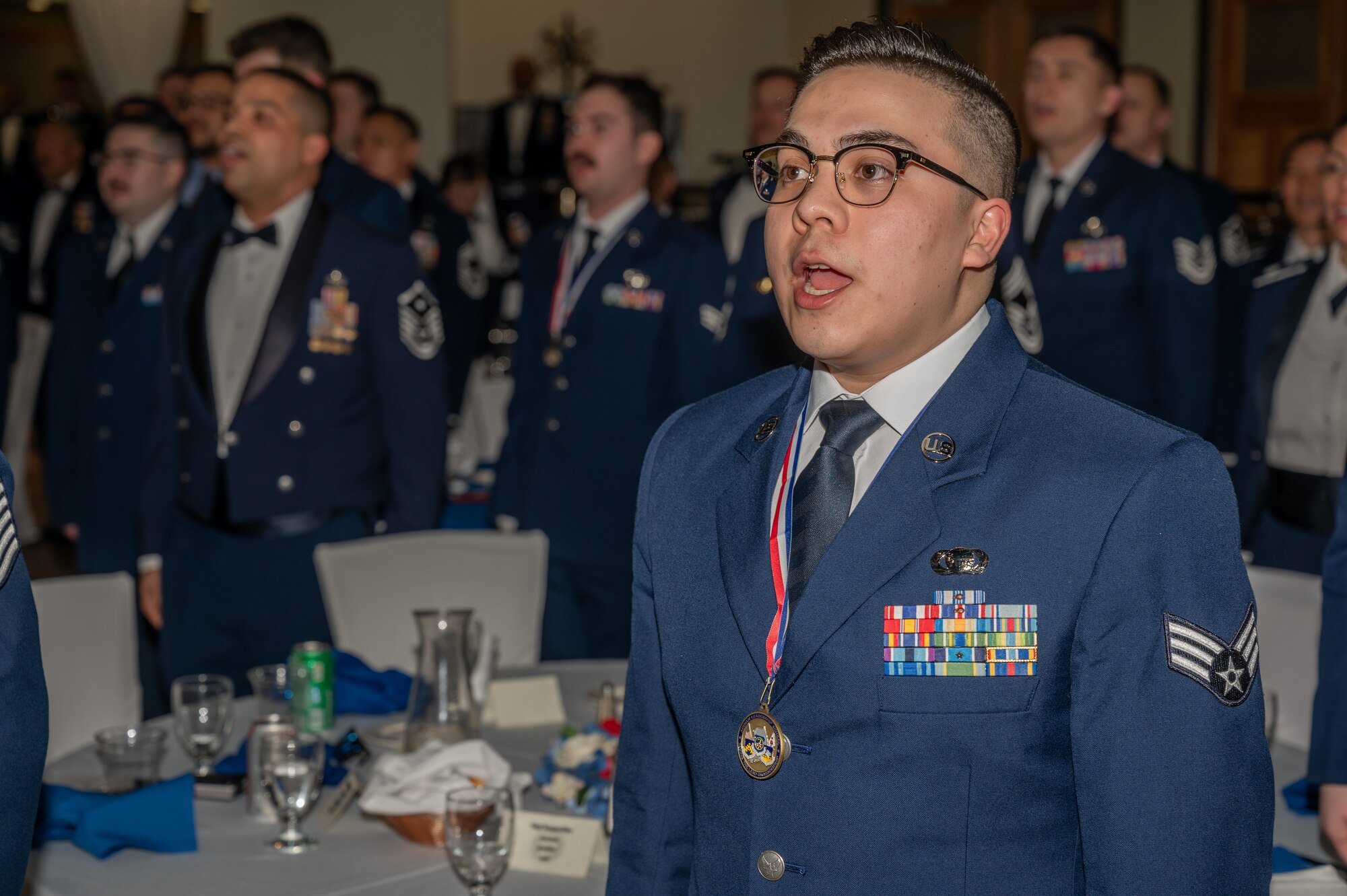 U.S. Air Force Senior Airman Derrick Carrasco, 303rd Intelligence Squadron cryptologic analyst, sings the Air Force song  during an Airman Leadership School graduation at Osan Air Base, Republic of Korea, March 21, 2024. ALS instills leadership skills necessary to develop other Airmen. (U.S. Air Force photo by Airman 1st Class Chase Verzaal)