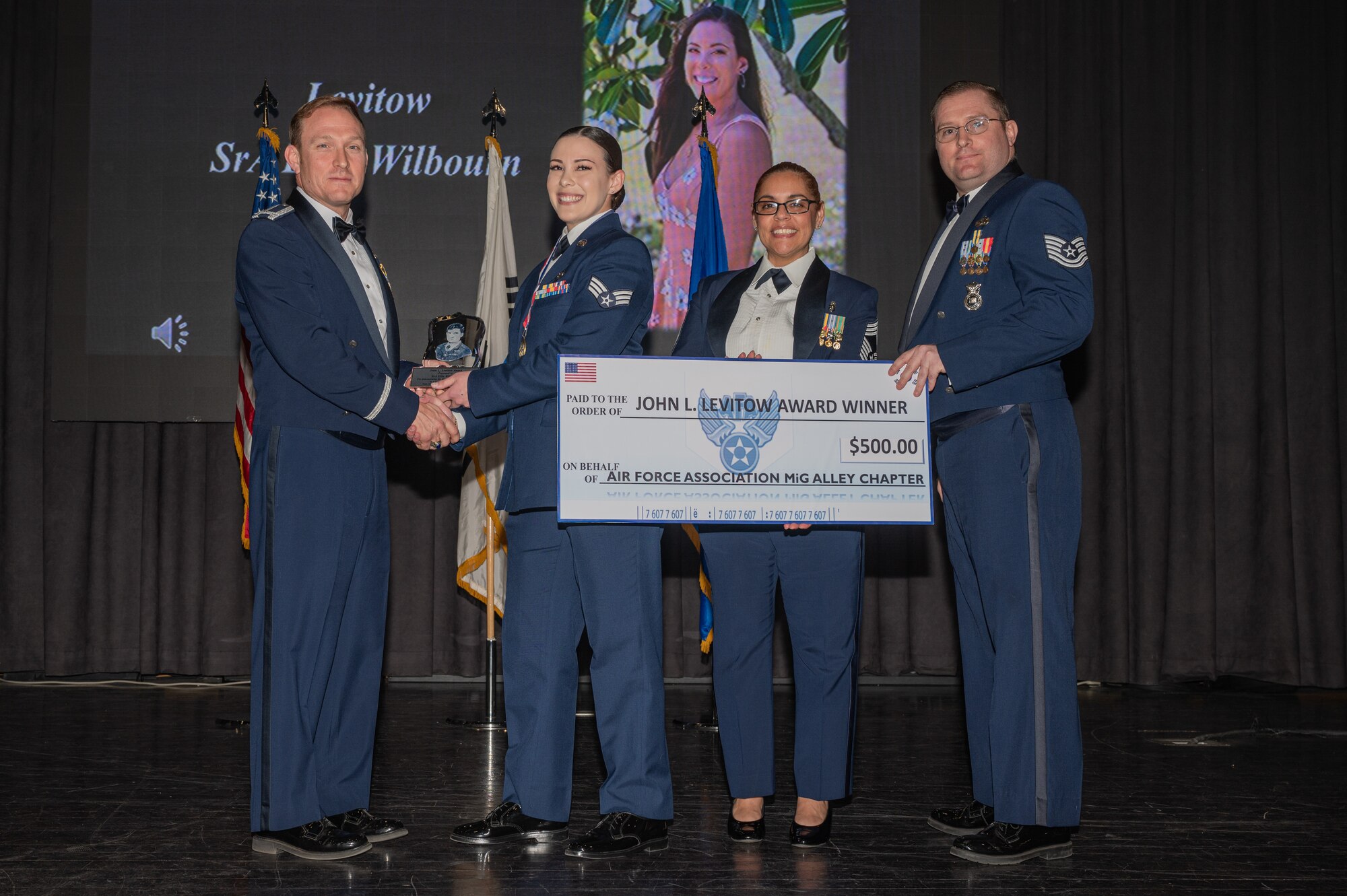 U.S. Air Force Senior Airman Ellie Wilbourn, 7th Air Force Joint Worldwide Intelligence Communications System administrator, is presented with the John L. Levitow Award during an Airman Leadership School graduation at Osan Air Base, Republic of Korea, March 21, 2024. The John Levitow Award is the highest honor presented to a graduate of Air Force Enlisted Professional Military Education. To be eligible for the award, a graduate must rank in the top 1% of his or her class. (U.S. Air Force photo by Airman 1st Class Chase Verzaal)