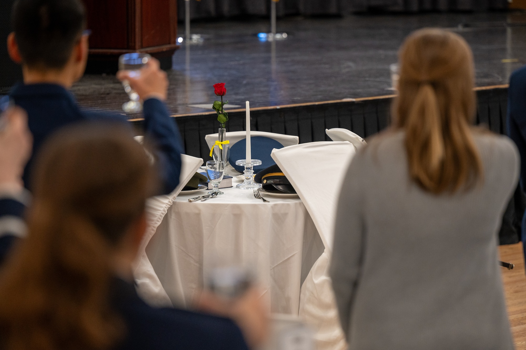 Attendees of an Airman Leadership School graduation raise their glasses in remembrance of service members who have become prisoners of war or gone missing in action at Osan Air Base, Republic of Korea, March 21, 2024. ALS is a 5 week-long course that is attended by Senior Airmen and Staff Sergeants to learn leadership skills and develop management capabilities. (U.S. Air Force photo by Airman 1st Class Chase Verzaal)