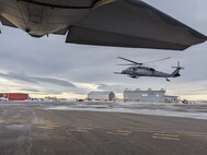 Framed by the tail of a 211th Rescue Squadron HC-130J Combat King II, a 210th Rescue Squadron HH-60G Pave Hawk, carrying 212th Rescue Squadron Guardian Angel personnel recovery Airmen, sorties from Unalakleet, Alaska, March 21, 2024. The HH-60 transloaded Guardian Angels to the HC-130 before continuing to Kotlik for a medical evacuation mission. 
Framed by the tail of a 211th Rescue Squadron HC-130J Combat King II, a 210th Rescue Squadron HH-60G Pave Hawk, carrying 212th Rescue Squadron Guardian Angel personnel recovery Airmen, sorties from Unalakleet, Alaska, March 21, 2024. The HH-60 transloaded Guardian Angels to the HC-130 before continuing to Kotlik for a medical evacuation mission.
