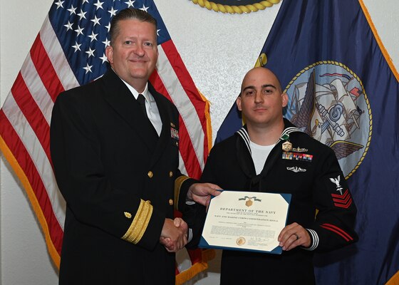 JOINT BASE SAN ANTONIO-FORT SAM HOUSTON – (March 29, 2024) – Hospital Corpsman 1st Class Thomas Minton, of Long Branch, N.J, assigned to Navy Medicine Training Support Center (NMTSC), was recognized by Rear. Adm. Walter Brafford, commander, Naval Medical Forces Support Command (NMFSC), as NMTSC’s Fiscal Year 2023 Sailor of the Year at NMFSC headquarters. NMFSC develops and delivers integrated education and training that produces operational medical experts to project Medical Power in support of Naval Superiority. (U.S. Air Force photo by Taylor Curry, 502 Air Base Wing Public Affairs/Released)