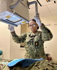 ALBANY, GA. (February 2, 2024) Hospital Corpsman 1st Class Twyia Manning, a radiology technician at Naval Branch Health Clinic Albany, adjusts the x-ray machine for an image of a sailor’s knee. Manning, a native of Valdosta, Georgia, says, “X-ray results help physicians provide a correct diagnosis.” (U.S. Navy photo by Deidre Smith, Naval Hospital Jacksonville).  #FacesofNHJax