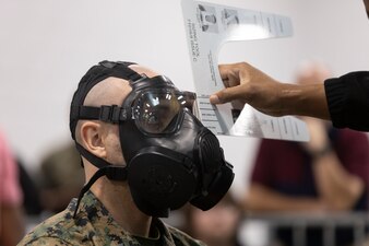 U.S. Navy Hospital Corpsman Third Class Brandon Buyce, a corpsman with 2nd Medical Battalion, 2nd Marine logistics Group, has a gas mask fitted to him during a Class II Advisory Working Group (CAG) tour at an Issues, Exchanges and Returns facility on Marine Corps Base Camp Lejeune, North Carolina, March 27, 2024. The tour was held to conduct a detailed analysis of requirements, equipment fielding and sustainment processes across the new II Marine Expeditionary Force Consolidated Storage Program under the Marine Force Consolidated Storage Command. (U.S. Marine Corps photo by Cpl. Antonino Mazzamuto)