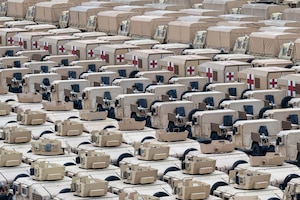 Vehicles in multiple lines fill a parking area.