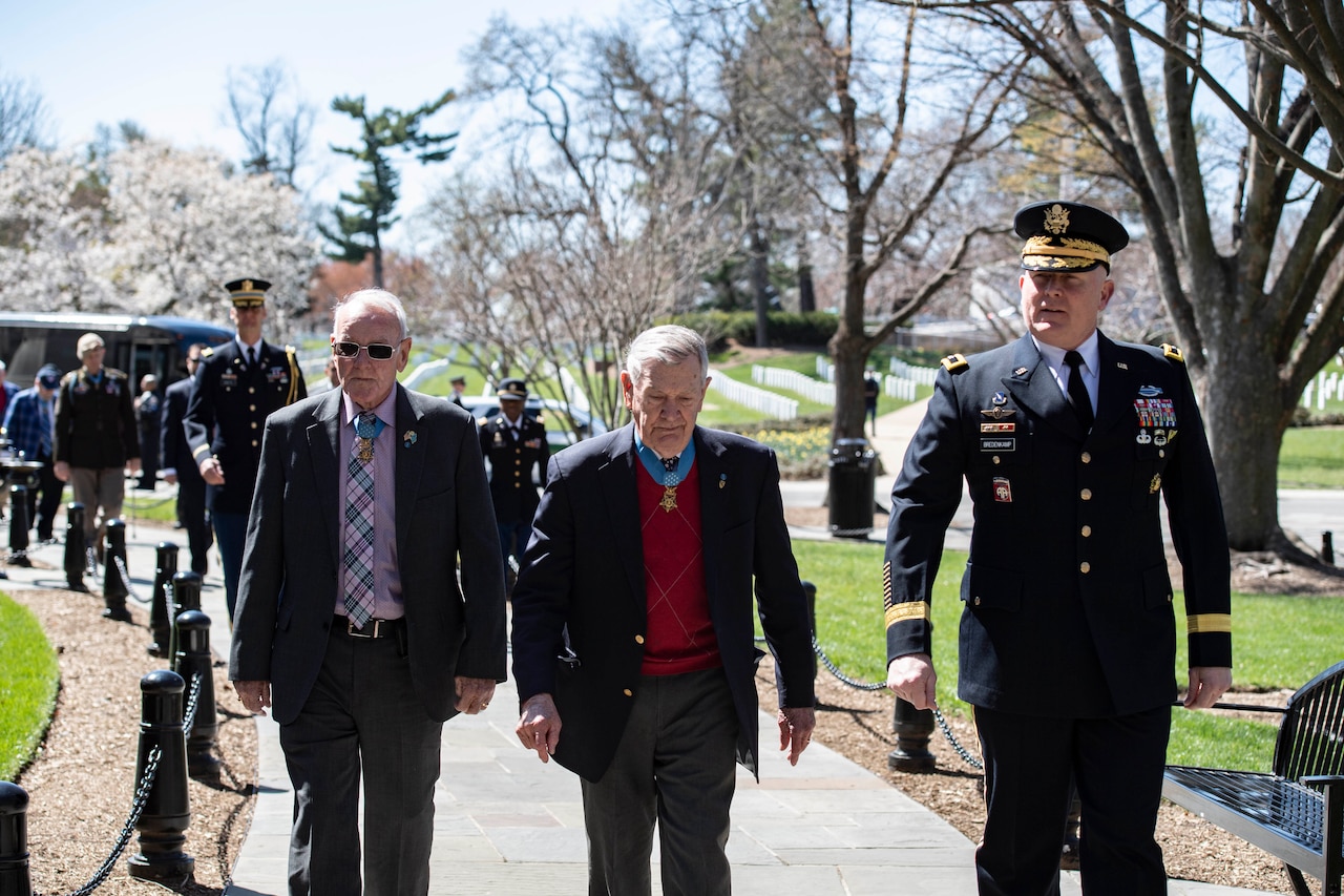 A group of people walk along a path.