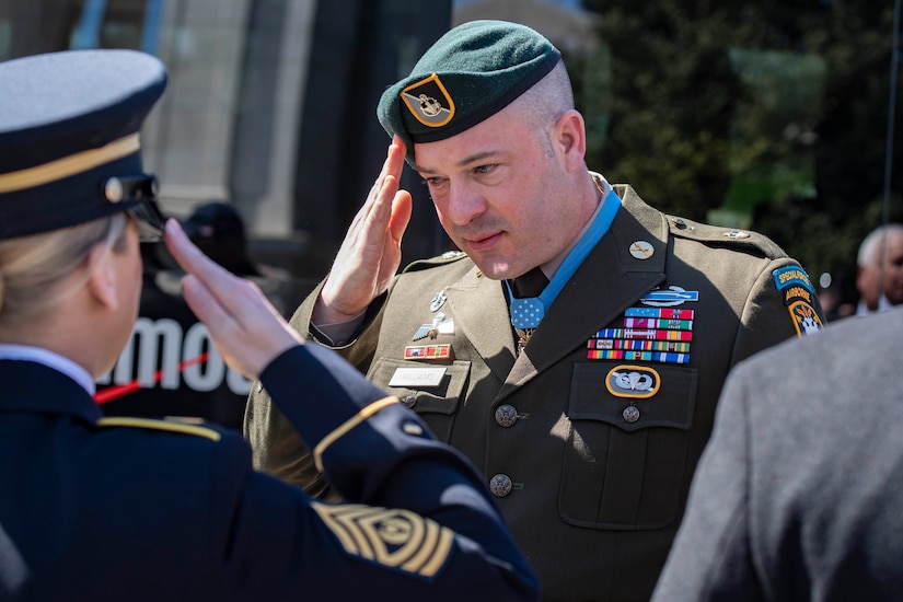 A military officer salutes another military officer.