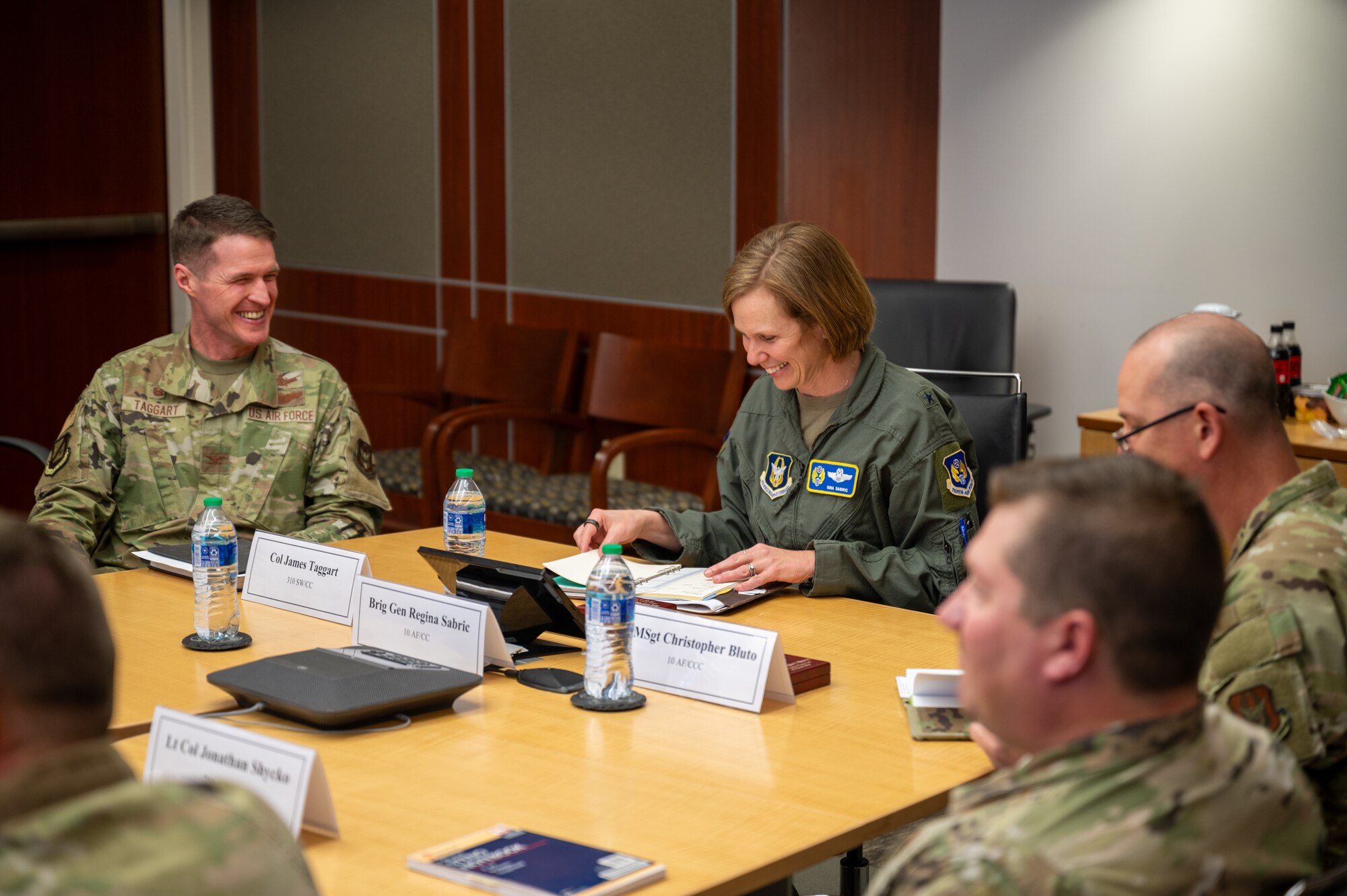 People in U.S. Air Force uniforms sitting at a table.