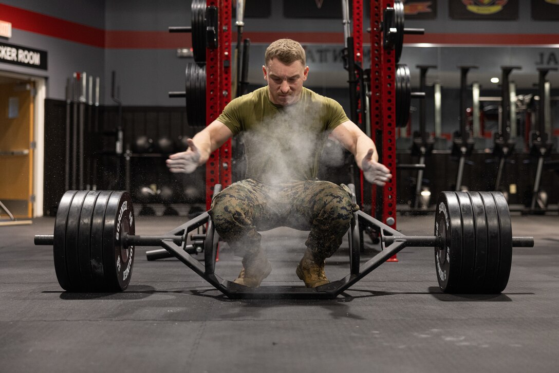 U.S. Marine Corps Cpl. Luke Stevens, Non-Commissioned Officer-In-Charge of the 2nd Marine Logistics Group Human Performance Center, and a native of Millington, Tennessee, slaps chalk on his hands to prepare for a deadlift on Camp Lejeune, North Carolina, March 27, 2024. Each week, 2nd MLG recognizes one outstanding Marine or Sailor that goes above and beyond in their duties and embodies the qualities of an outstanding service member. Stevens’ outstanding accomplishments resulted in his selection to the Commanding General’s Human Performance Center initiative, where he manages unit scheduling, all logistical requirements, and daily facilities management. His accomplishments in this role include, briefing the HPC capabilities to executive staff and officers, and supporting daily activities that resulted in the training of more than two thousand 2nd MLG Marines and Sailors. When asked what his goals were while being a member of the HPC, Stevens said, “I want to set the example to my fellow Marines and Sailors on how total fitness can better your lives inside and outside of the Corps.” (U.S. Marine Corps photo by Cpl. Mary Kohlmann)