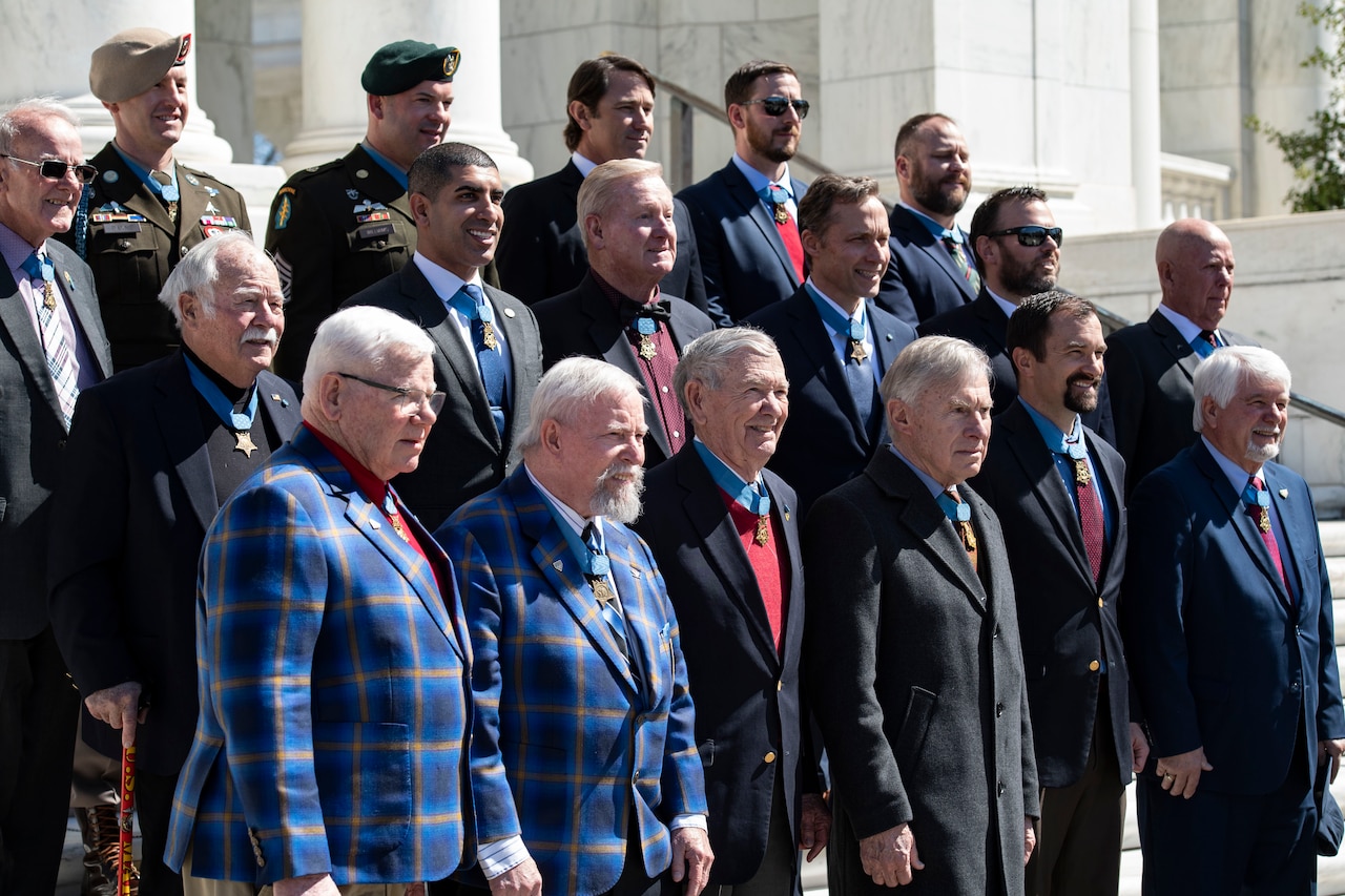 A group of people stand together for a photograph.