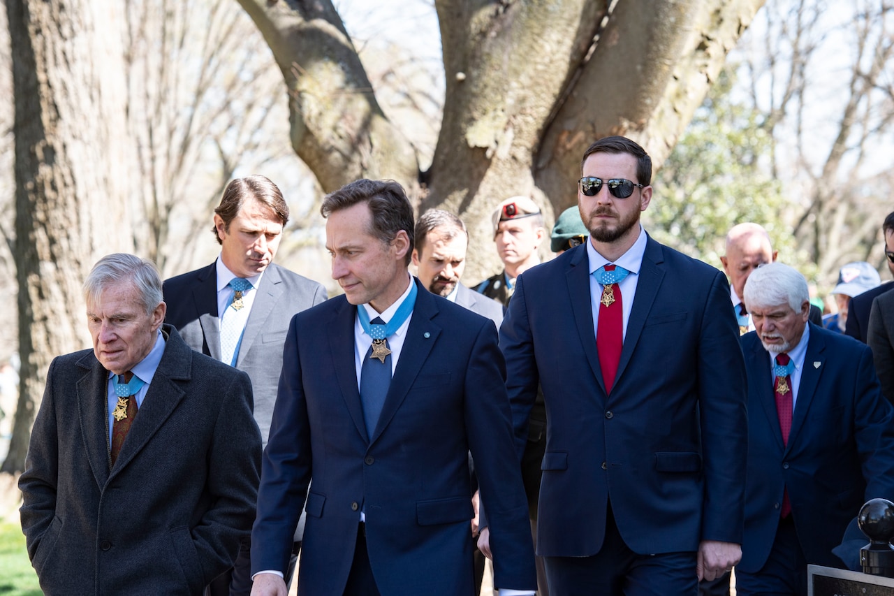 A group of people walk toward the camera.