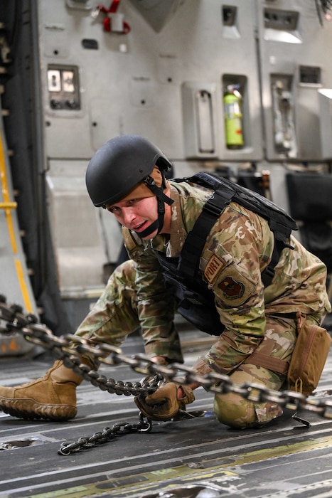 U.S. Air Force Senior Airman Alexander Fickas, 97th Logistics Readiness Squadron aerial operations apprentice, secures a humvee in a C-17 Globemaster III at Altus Air Force Base, Oklahoma, March 28, 2024. Through realistic training exercises like Caduceus Spear, participants gain invaluable experience, facing real-world scenarios to ensure readiness for any situation.  (U.S. Air Force photo by Airman 1st Class Jonah G. Bliss)