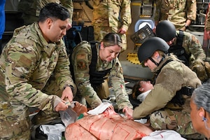 Airmen from the 97th Security Forces Squadron and the 97th Medical group perform tactical combat casualty care (TCCC) in a C-17 Globemaster III at Altus Air Force Base, Oklahoma, March 28, 2024. These airmen were administering TCCC as part of the Caduceus Spear exercise, where patients were evacuated from a simulated hostile environment and cared for during flight. (U.S. Air Force photo by Airman 1st Class Jonah Bliss)