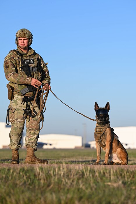 U.S. Air Force Staff Sgt. Donovan Saona, 97th Security Forces Squadron (SFS) K9 handler, secures the perimeter with Biko, 97th SFS military working dog, at Altus Air Force Base, Oklahoma, March 28, 2024. Saona and Biko participated in the Caduceus Spear exercise and ensured the safety of the area of operation. (U.S. Air Force photo by Airman 1st Class Jonah G. Bliss)