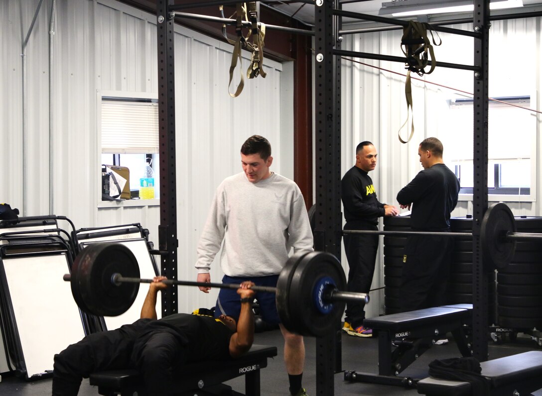 Air Force Staff Sgt. Alex Potts coaches a Soldier through an hour-long upper body training session. Instructors from the 83rd U.S. Army Reserve Readiness Training Command, under the 100th Training Divisions, certified 26 soldiers with the Holistic Health and Fitness Integrator (H2F1) additional skill identifier (ASI).