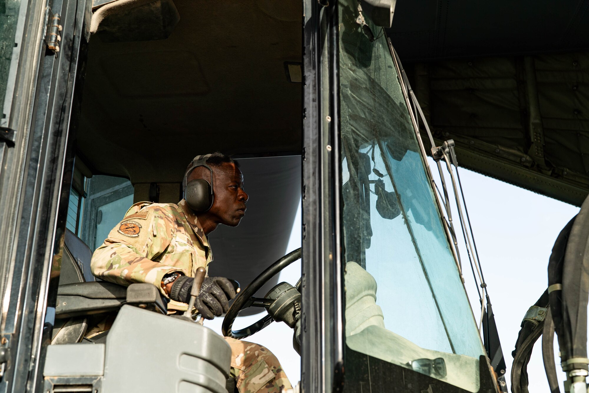 An Airman operates a forklift truck to load pallets of humanitarian aid destined for Gaza onto a C-130.