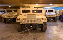 A photo of several Humvees parked on a ship.