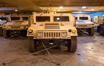 A photo of several Humvees parked on a ship.
