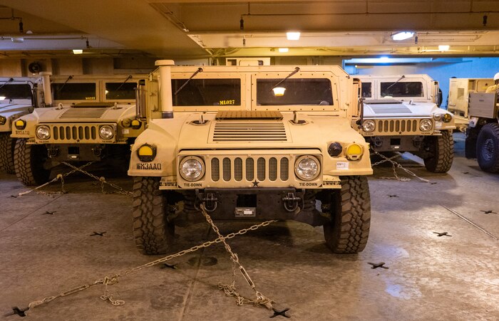 A photo of several Humvees parked on a ship.