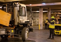 A photo of a man directing a large truck.