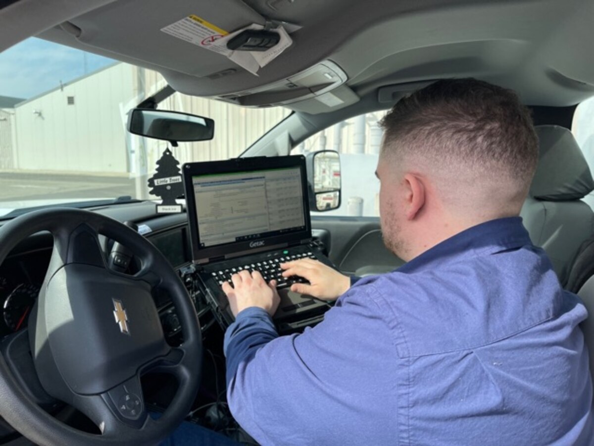 Technician entering data into computer