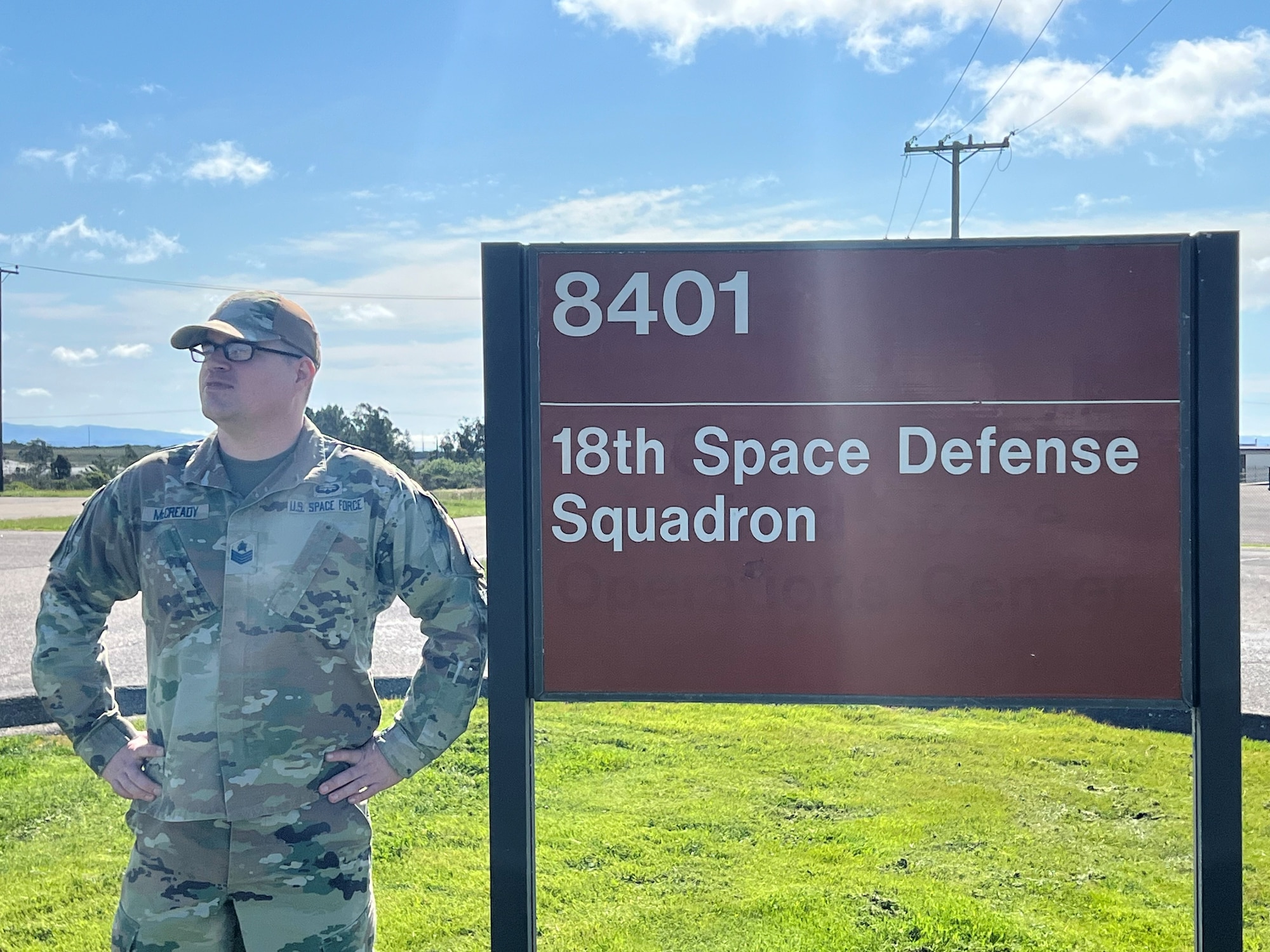 1002: U.S. Space Force Tech. Sgt. Nathaniel McCready, flight chief for Space Delta 2 – Space Domain Awareness and Space Battle Management’s 18th Space Defense Squadron, stands in front of the 18 SDS’s building sign on Vandenberg Space Force Base, California, March 22, 2024. McCready, a former U.S. Army satellite communication systems specialist, co-founded the Guardian-Airmen Apprenticeship program with the hopes of providing junior service members with constructive mentorship opportunities. (U.S. Space Force photo by Julian Labit)